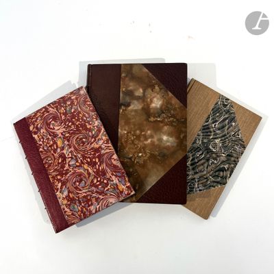 three different types of notebooks sitting on top of a white surface