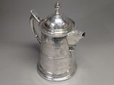 une cafetière ancienne en argent ornée d'un oiseau sur le couvercle