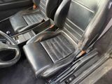 two black leather seats in the back of a car