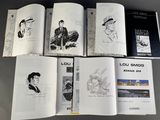 a lot of books that are sitting on a table