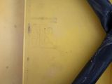 a close up view of a black pipe on a yellow box