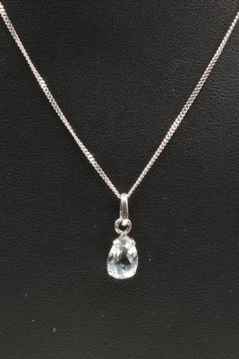 a necklace with a blue topaz stone on a silver chain