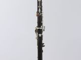 a black and white clarinet sitting on top of a white table