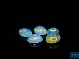 four oplites in a row on a black surface