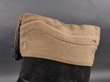 an image of a hat with a tassel on top of a mannequin ' s head