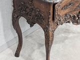a small table with a marble top on a tile floor