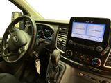 a car dashboard with a steering wheel and a tablet on the dashboard