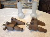 three vases on a table with a wooden plane on it