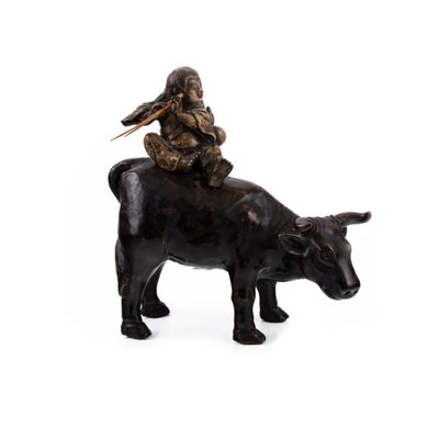figurine représentant un homme chevauchant une vache, avec un oiseau sur le dos