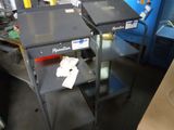 two machines that are sitting next to each other in a room