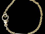 a gold chain bracelet with a small bar on it