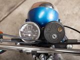 a close up of a motorcycle with a speedometer on it ' s handlebars