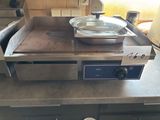 a pan sitting on top of a stove in a kitchen