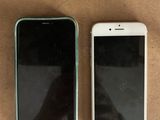two iphones sitting next to each other on a table