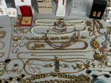 many different types of jewelry displayed on a table