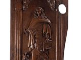 a wooden plaque depicting a man with a dog and a cat