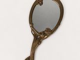 an image of a small bronze mirror with a bird on it