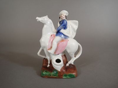 a figurine of a man riding on a horse