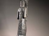 an image of a statue of a woman sitting on a rock