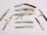 many different types of knives on a white surface