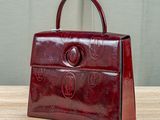 an image of a red purse on a wooden table