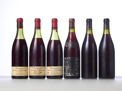 six bottles of wine lined up in a row on a table