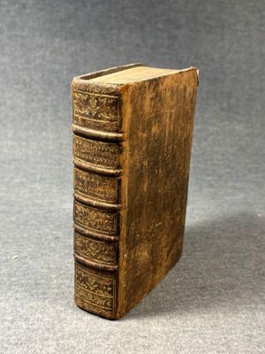 a close up of an old book on a gray surface