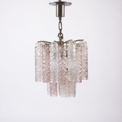 a close up of a glass chandelier hanging from a ceiling