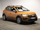 the orange car is parked in a white room with checkered floor