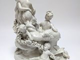 an image of a statue of a group of people sitting on a rock