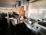 a kitchen with a stove, sink, stove top and a stove top oven
