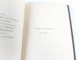 an open book on a white table with a black border