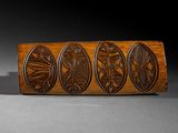 an image of a close up of a piece of wood with carvings on it