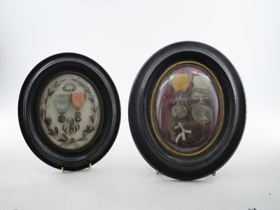 pair of black and gold picture frames with a picture of a man and a woman