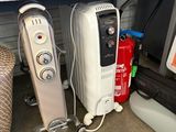 two electric heaters sitting on a shelf in a room