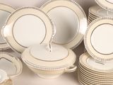 a lot of plates and bowls that are sitting on a table