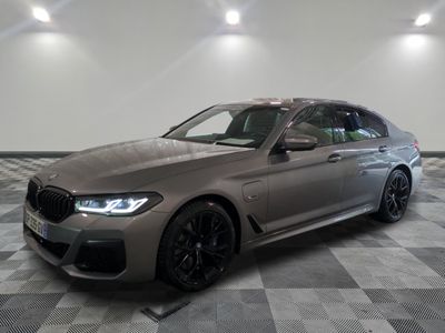 the bmw m5 competition wagon is parked on a checkered floor