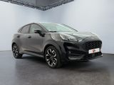 a grey ford kad is parked in a large room