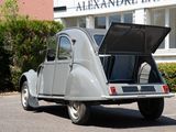 an old car that is parked in front of a building