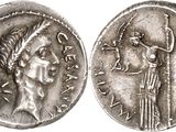 a silver coin with an image of a woman and a man on it