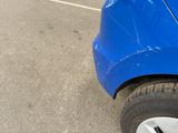 a blue car that is parked in a parking lot