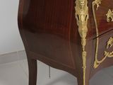 a marble top chest of drawers with a marble top