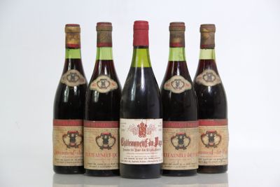 six bottles of red wine are lined up on a table