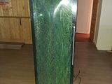 a large green aquarium in the middle of a room