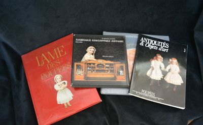 three children ' s books are sitting on a black cloth