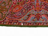 a close up of a red, green, and blue rug