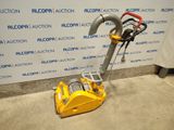 a close up of a machine on the ground near a wall