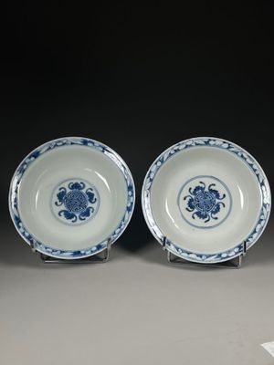 pair of blue and white plates with flowers on them