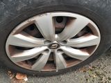 the tire of a white car with a flat tire on the ground