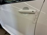 a close up of a car door handle with a sticker on it